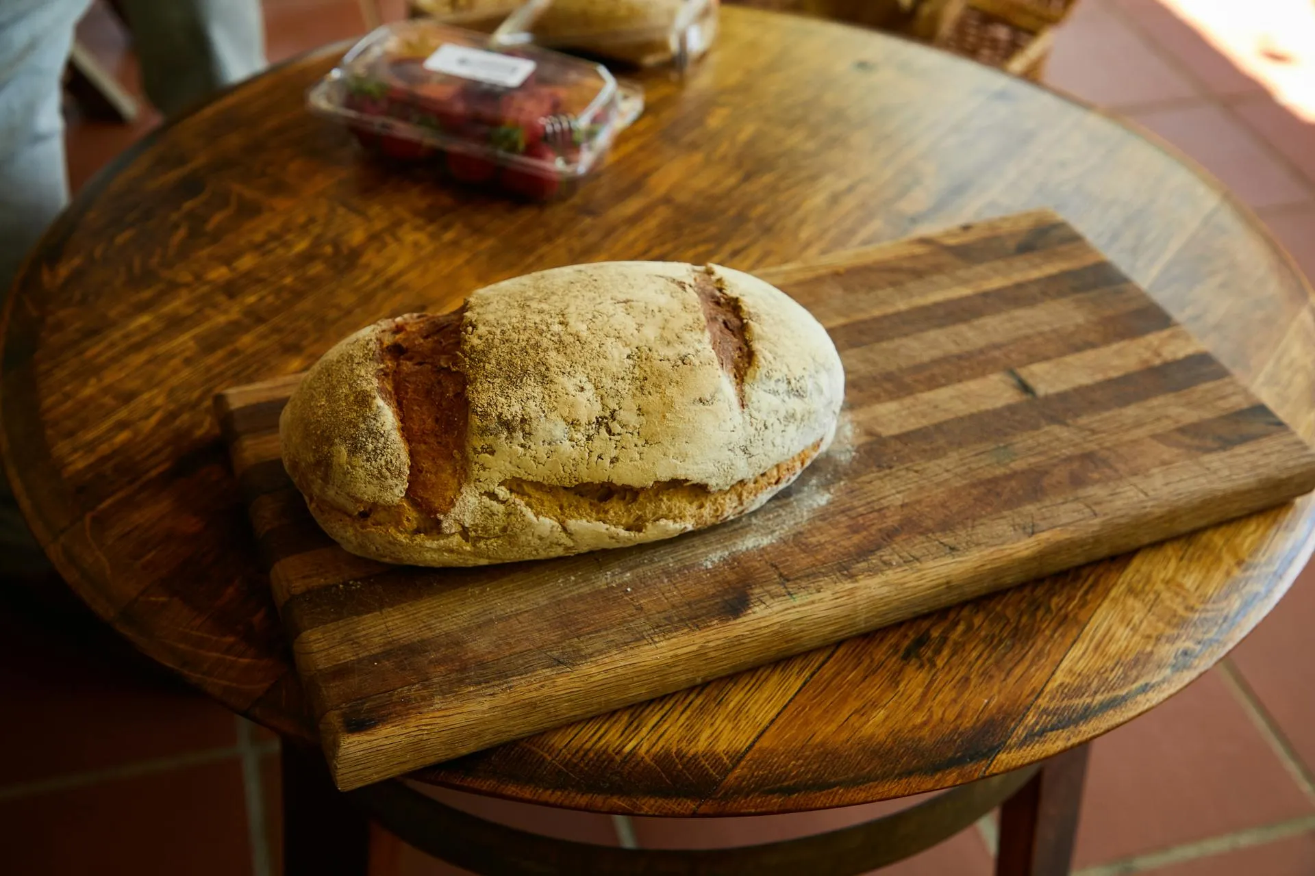 Artisan bread loaves on a rustic wooden table in warm light