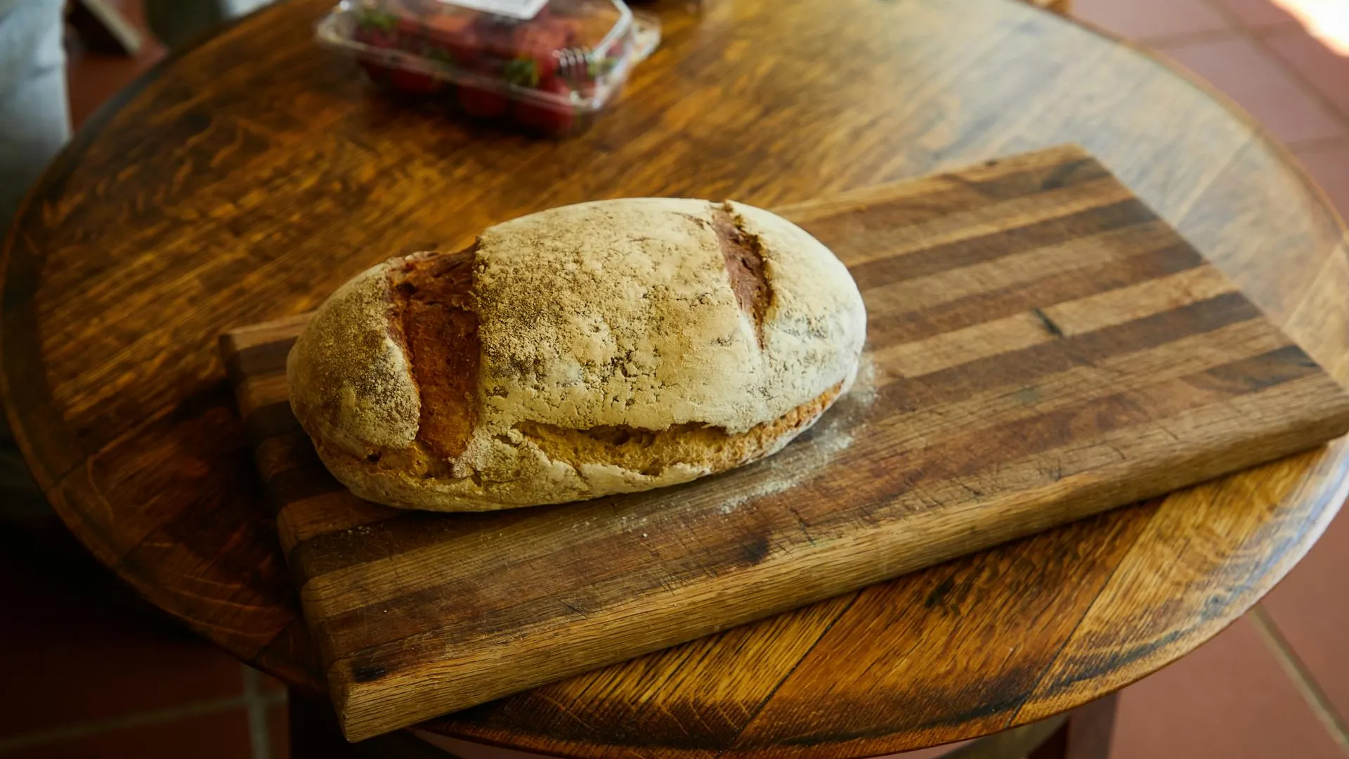 Artisan bread loaves on a rustic wooden table in warm light